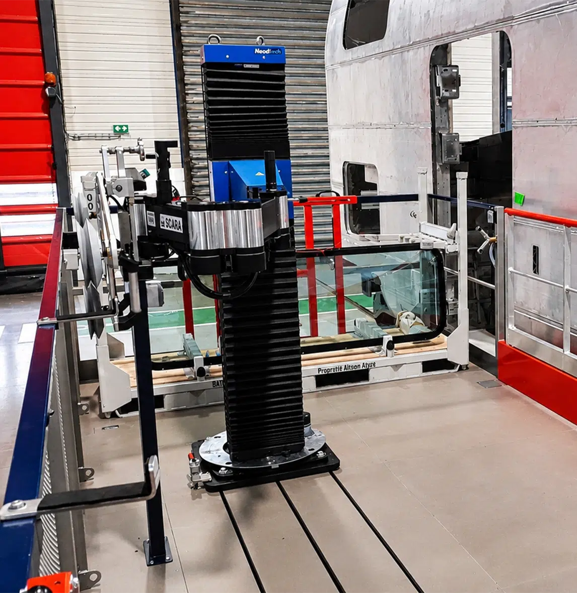 SCARA TITAN manipulator arm at a glazed unit assembly station on a high-speed train