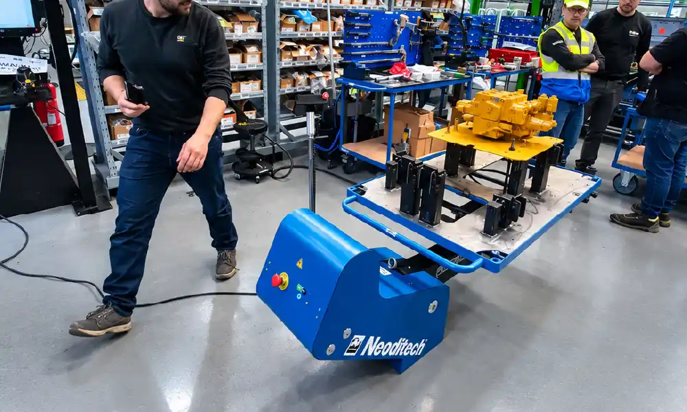 Agricultural machinery material handling: Neoditech ERGO360 ergonomic positioner holding a hydraulic valve block